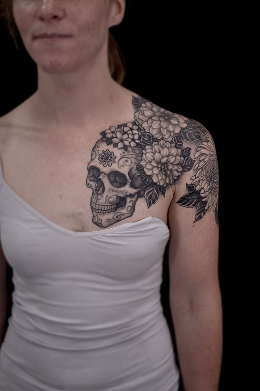 Sugar Skull and Floral Chest Piece Tattoo by Adam LoRusso artist black and grey 