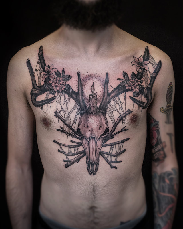 Tattoo by Adam LoRusso artist black and grey boston skull chest piece