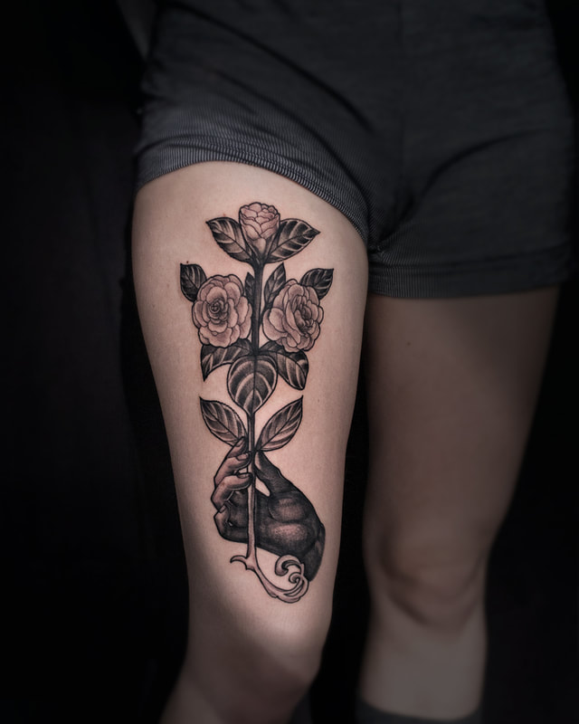 Tattoo by Adam LoRusso artist black and grey boston hand holding rose tattoo